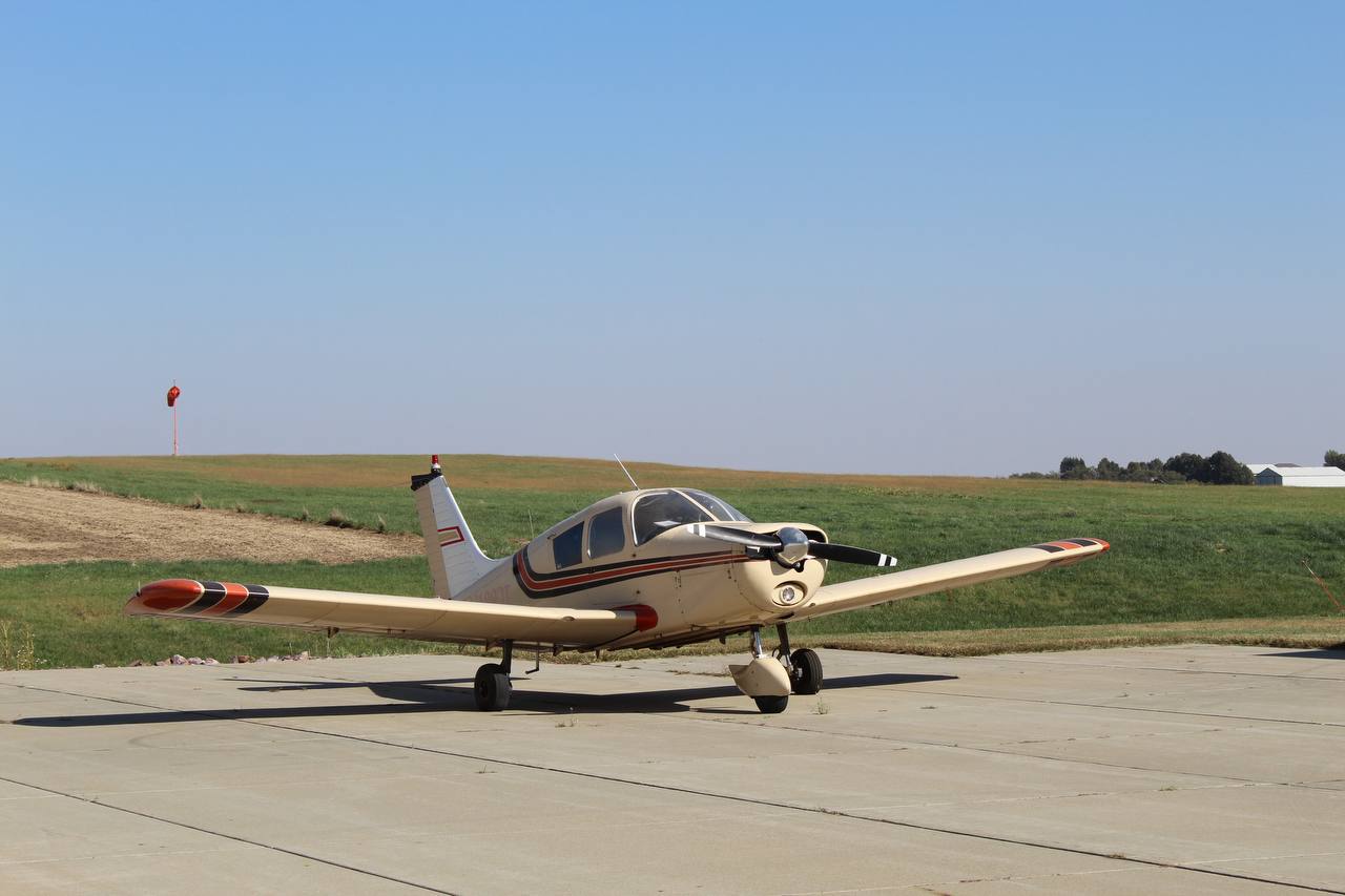 Piper Cherokee on the ramp at sunset